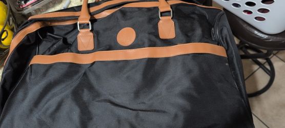 Vince Camuto duffel bag in black and brown with a nylon body and vegan leather trim