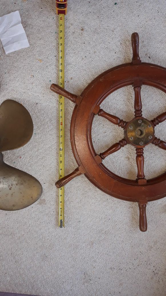 Ships wheel, antique brass prop, and Alaskan drift net floats decor