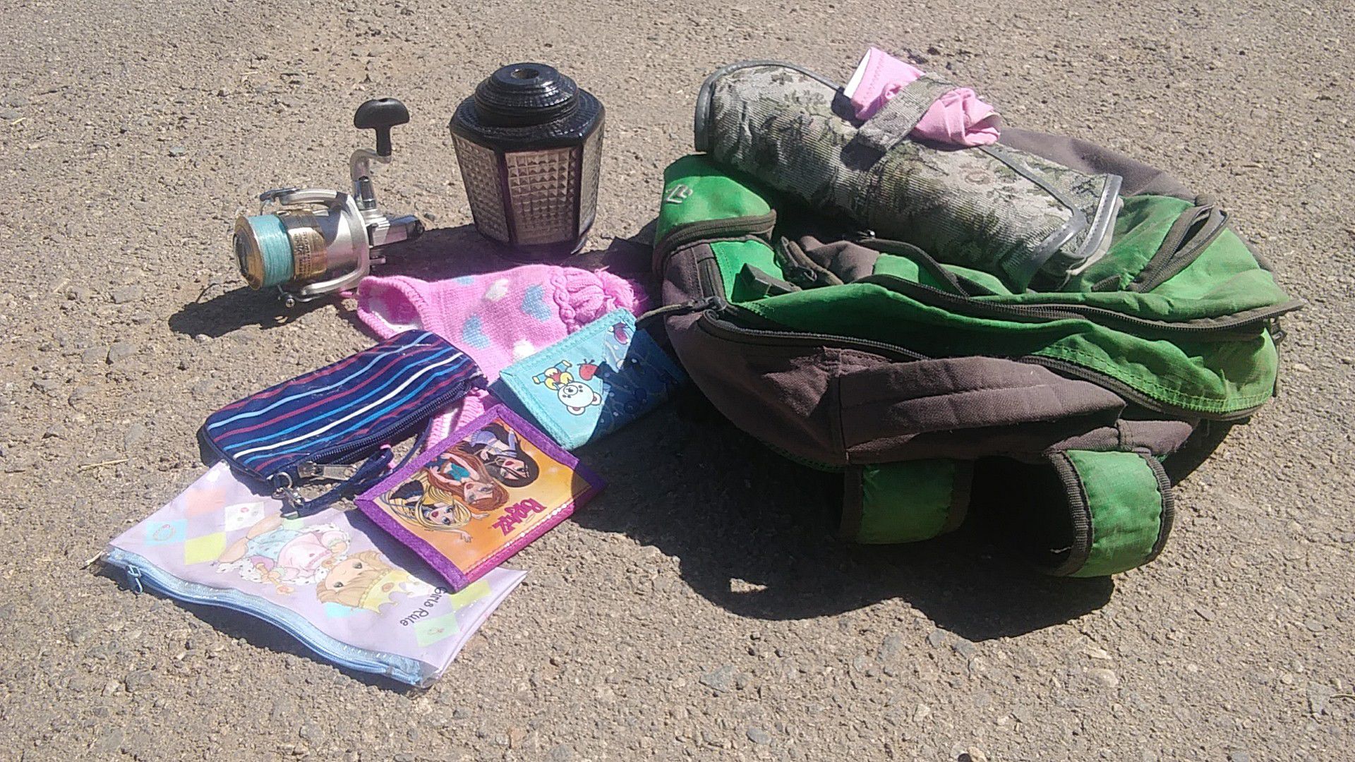 Odds and Ends. Fishing reel, girls purses, backpack, toiletry bag, girls snow cap, porch lantern, Etc.