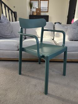 Garbar Elba chair with arms, made of polypropylene and suitable for both indoor and outdoor use.