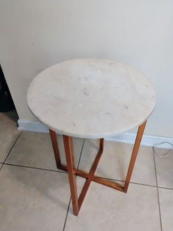 round table with marble top and copper base