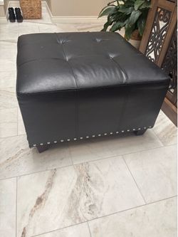 Black faux leather ottoman