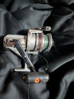 Two vintage fishing reels. One is a Ryobi silver cloud and the other one is a Shimano