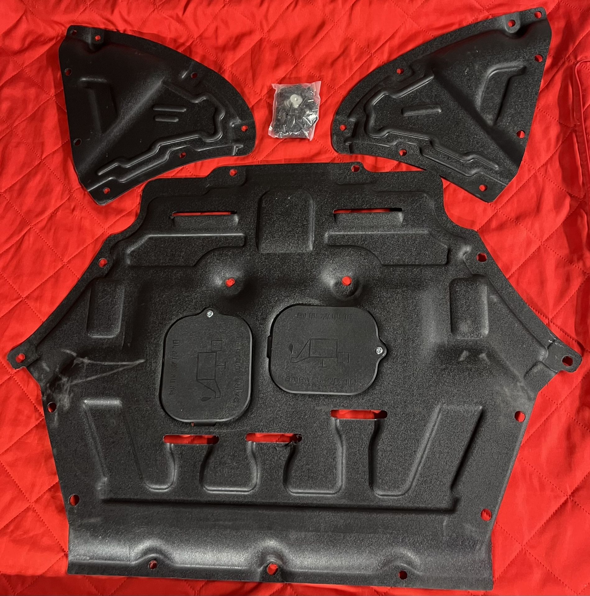 The Lower Engine Cover for Audi Q7 2017-2024 is a heavy-duty engine shield guard made of durable black plastic. It includes mounting hardware for easy