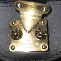 This is a Louis Vuitton Calfskin Duffle Bag in black leather with gold-tone hardware. 