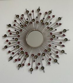 Beautiful sun shaped wall mirror with metal spokes and colored cups as pictured. 36 inch overall circumference. Mirror 8 inch.