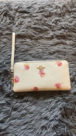 Coach wristlet with gold hardware and floral design