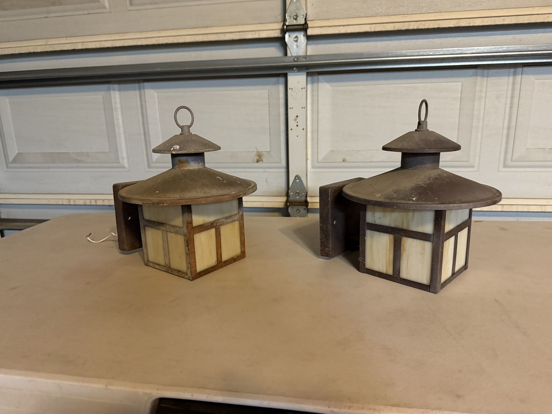 Two metal outdoor wall lighting fixtures