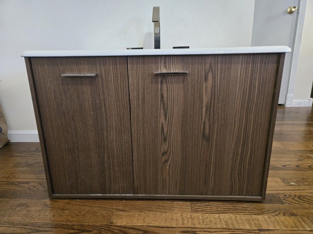 Wall mounted Kohler walnut flax cabinet with Enameled cast iron vanity top with rectangular sink