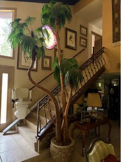 12 ft. Artificial almost natural palm tree in a decorative Chinese fish bowl planter.