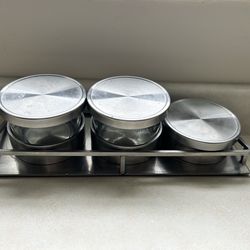 This is a Cal-Mil stainless steel 3-jar mixology/condiment display set (also called a bar garnish tray or caddy).