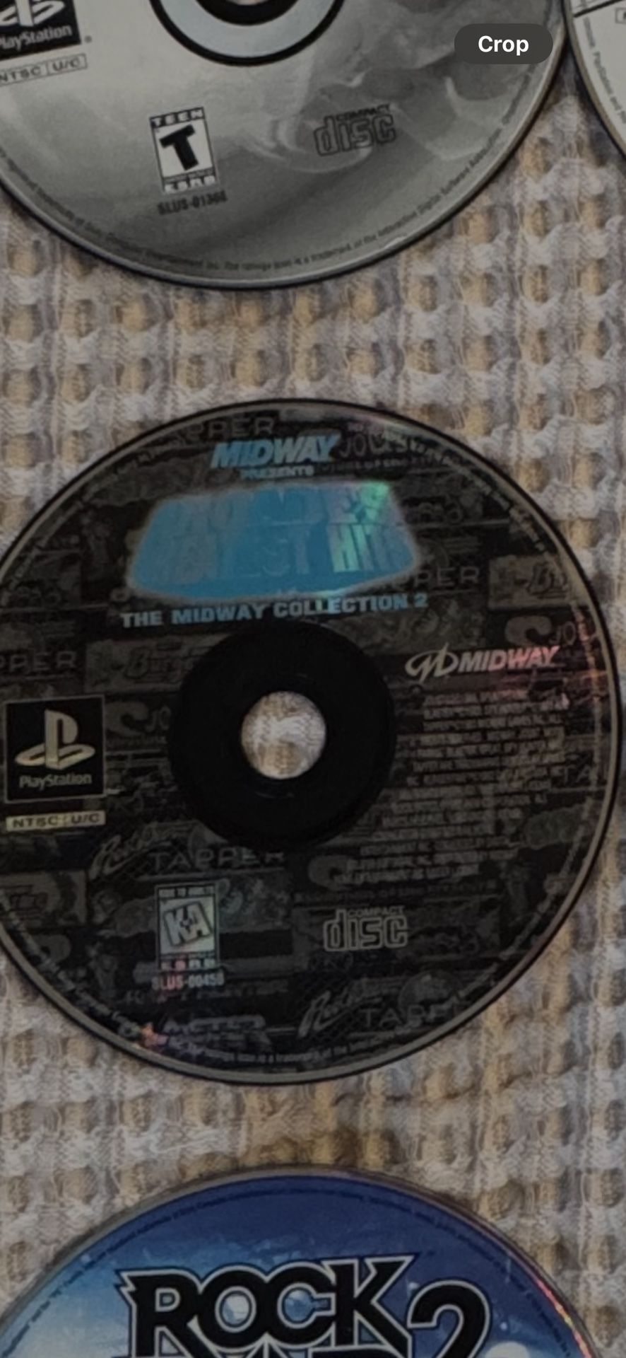 PlayStation game disc titled "Arcade's Greatest Hits: The Midway Collection 2."