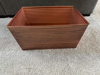 Copper colored metal storage bin