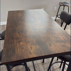 Brown and Black Dinner Table With Stools