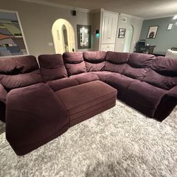 Sectional Sofa In Purple With Reclining Seats And Large Matching Storage Ottoman