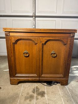 Smith Brothers Solid Oak Sewing Cabinet with Fold-Out Wings and Machine Lift