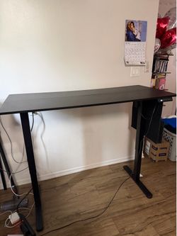 Adjustable Black standing desk.