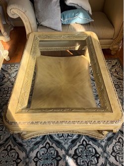 Carved wood coffee table with Glass top