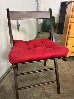 4 wood folding chairs with red pads
