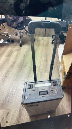 Versatile portable power station with a silver and black exterior. This unit has multiple USB ports, AC outlets, and a digital display for monitoring