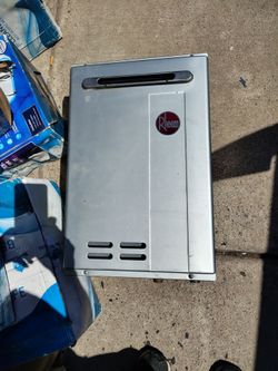 This is a Rheem Performance Plus outdoor natural gas tankless water heater, designed for high-efficiency, continuous hot water.