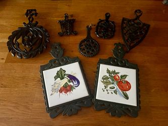 A Collection of 7 Vintage Cast Iron Trivets