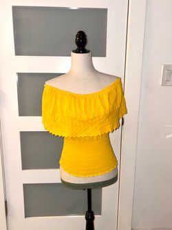 L.A. New York yellow off-the-shoulder blouse features a fitted design with a honeycomb pattern and a ruffle at the chest.