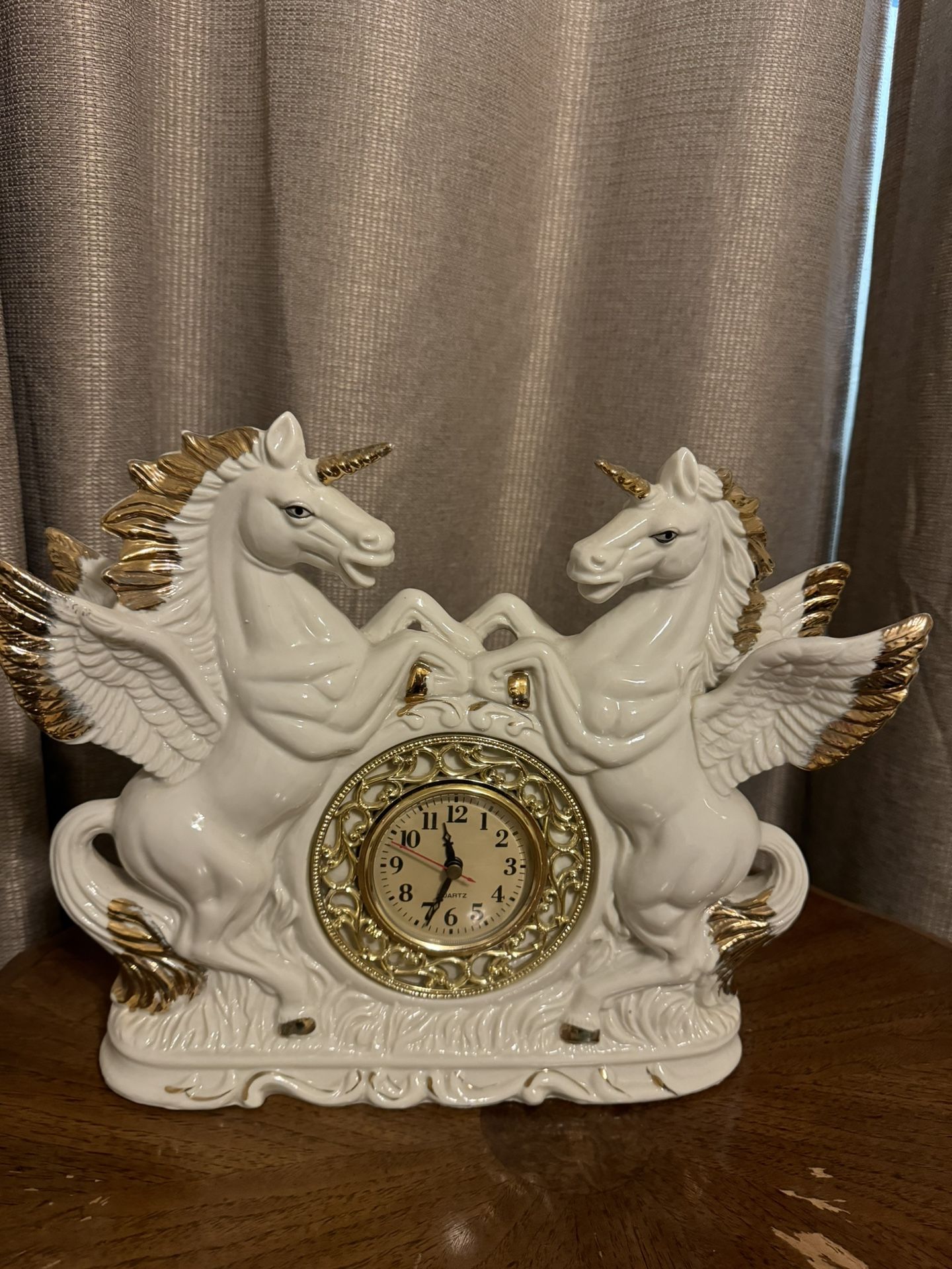 It’s a vintage clock with white porcelain unicorns