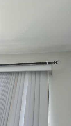 Long curtain rod with custom hooks