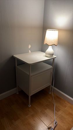White nightstand with small table lamp