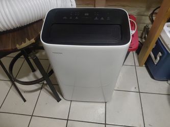 Toshiba portable AC unit w remote and exit tubing.