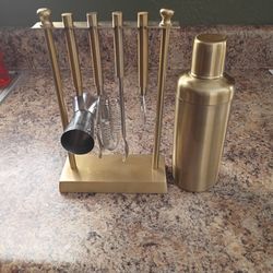 A Gold Medal Bar Tool Set With A Gold Cocktail Shaker
