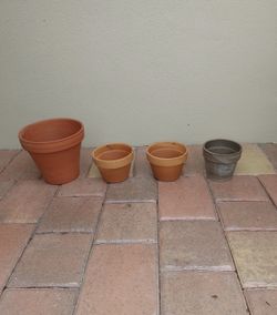 Preowned set of four small clay flower pots great for orchids