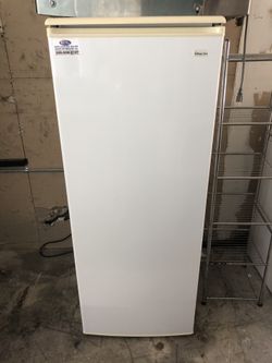 A white stand up Magic Chef refrigerator