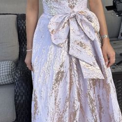 Strapless formal gown in blush/champagne.