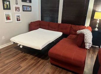 Ashley Furniture Sectional sofa with pull out bed and ottoman