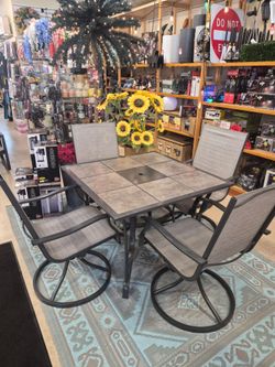 New 5 piece outdoor patio set. Tile Top table with 4 swivel chairs