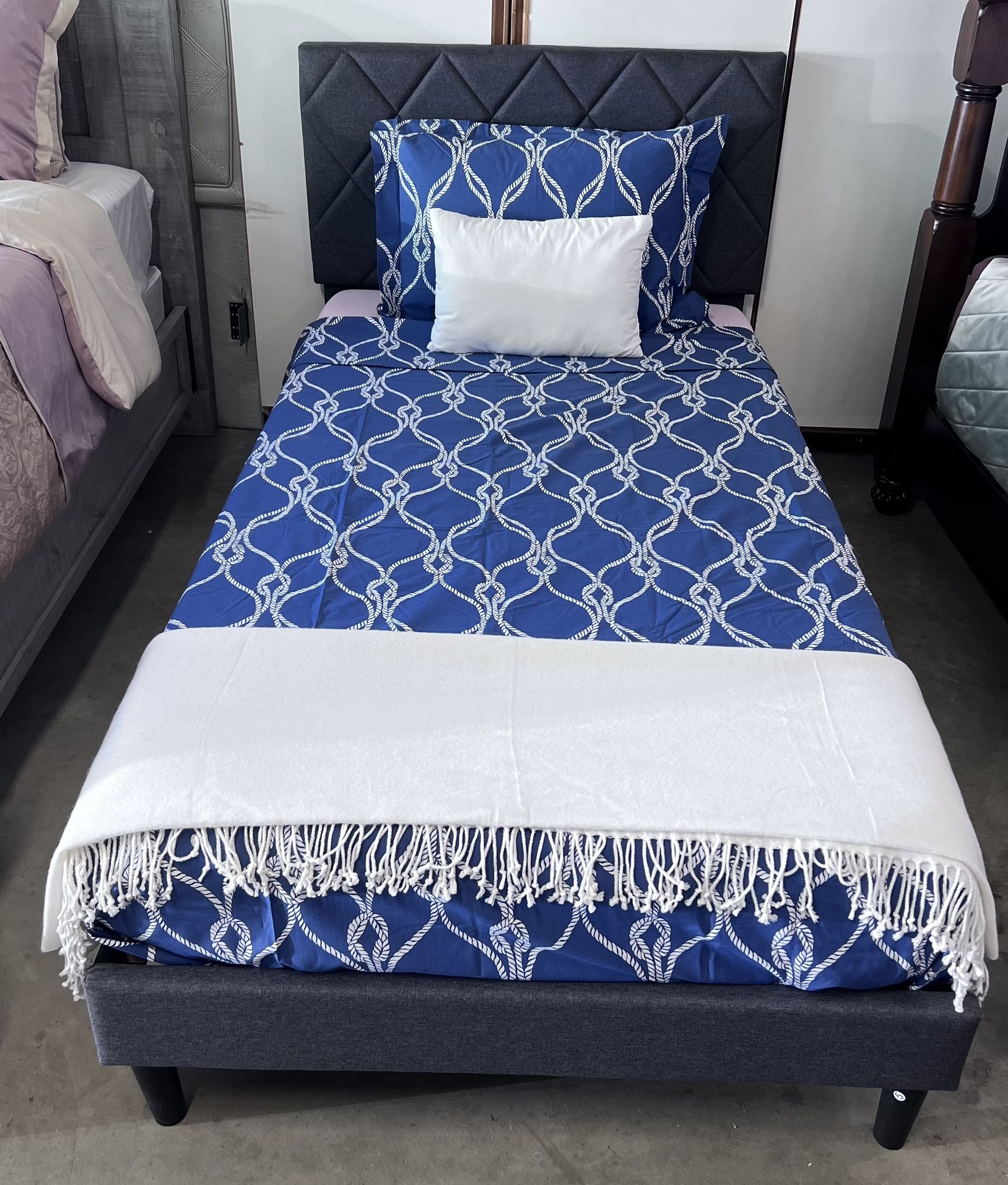 Twin size bed brand new bed frame and a slightly used memory foam mattress.