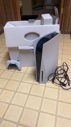 PlayStation 5 with controller and cables