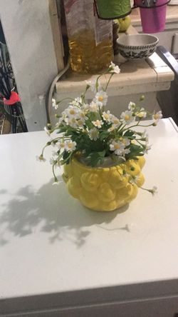 Vase of lemons with flowers