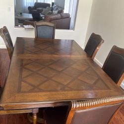 A Brown Six Piece Table With A Leaf