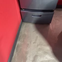 Storage drawer under the washer and dryer