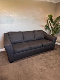 Contemporary Couch dark gray, black three-seater sofa style with flared arms.