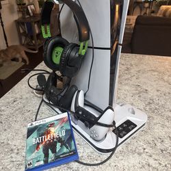 Ps5 with 2 remotes, charging stand,  headset, 1 game