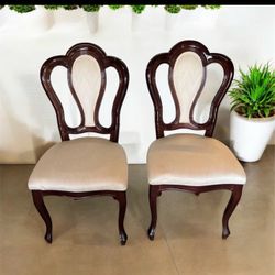Like New Traditional-style dining chairs with a dark cherry-colored mahogany wood frame and cream-colored patterned upholstery. The chairs feature a d