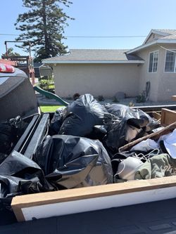 Truck bed full of bags of clothes and shoes. A lot of the stuff is new with tags. Mostly women clothing and shoes. Some furniture and decor. Portable