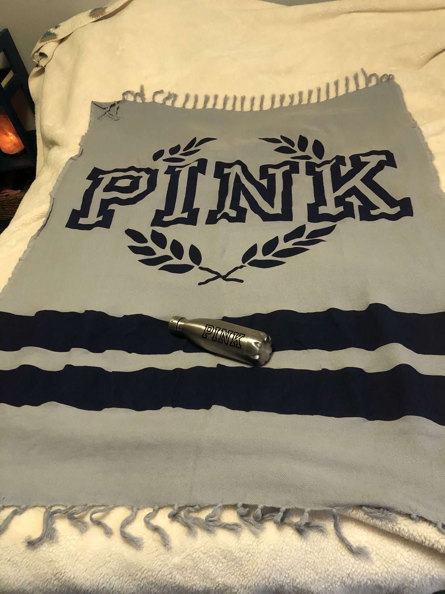 Pink throw blanket and water bottle