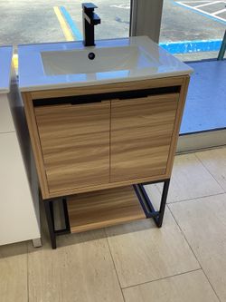 24” vanity, walnut, metal legs, ceramic top, available for pick up