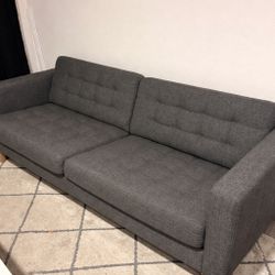 Modern gray fabric couch with tufted stitching