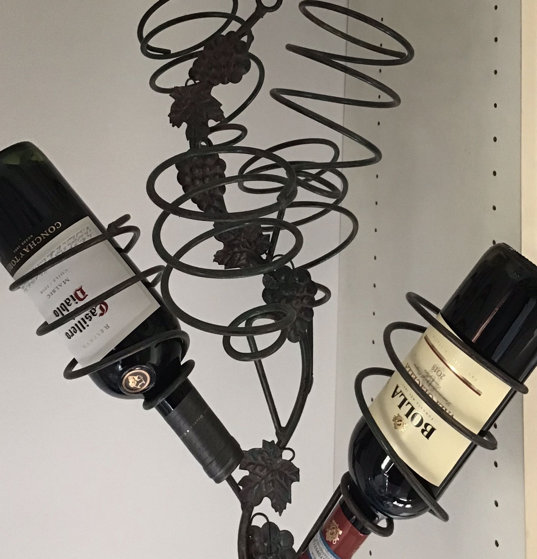Hanging wrought iron wine rack with grapes, holds 5 bottles